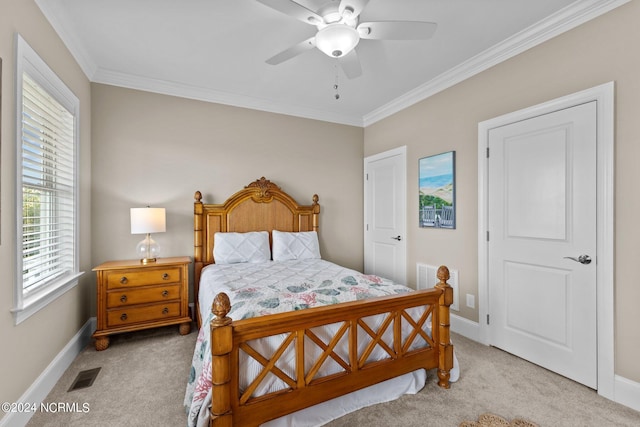 carpeted bedroom featuring ornamental molding, visible vents, and baseboards