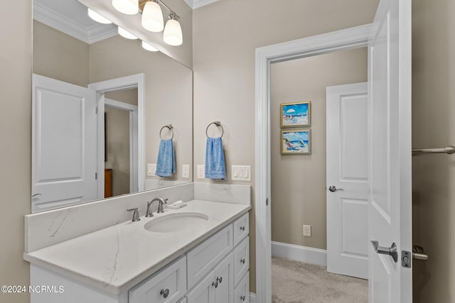 bathroom featuring ornamental molding, vanity, and baseboards