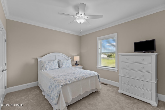 bedroom with light carpet, a ceiling fan, baseboards, and crown molding