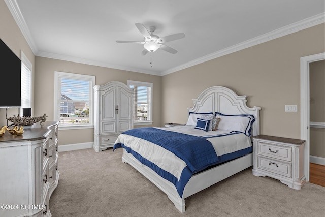 bedroom featuring a ceiling fan, light colored carpet, crown molding, and baseboards