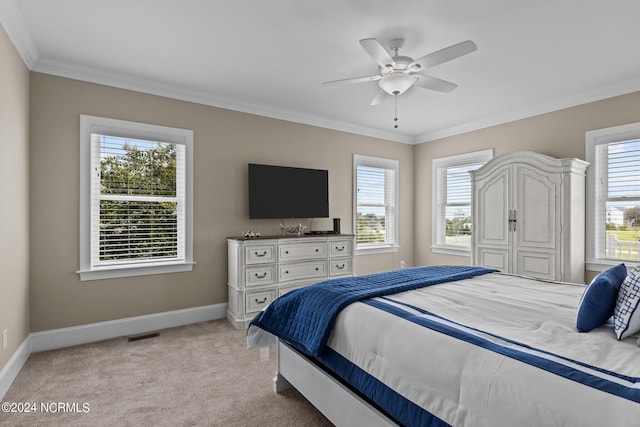 carpeted bedroom with multiple windows, crown molding, and ceiling fan