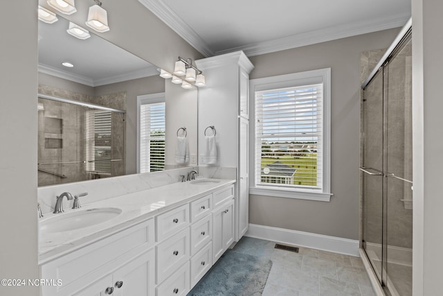 bathroom with crown molding, tile patterned floors, a shower with door, and vanity