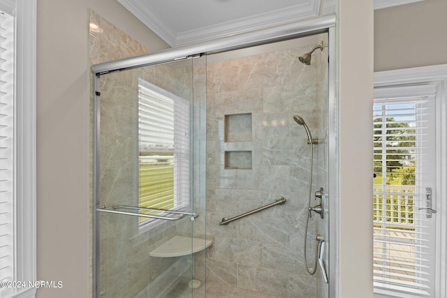 bathroom with ornamental molding and a shower stall