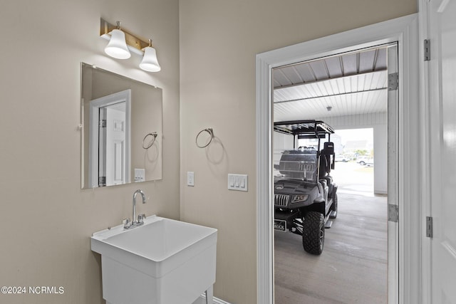 bathroom with a sink and wood finished floors