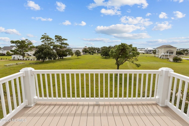 wooden terrace with a lawn