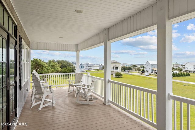 wooden deck with a yard and a residential view