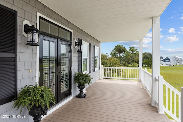 wooden terrace featuring a porch and french doors