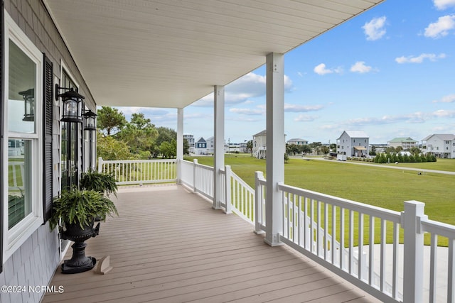 wooden deck featuring a yard and a residential view