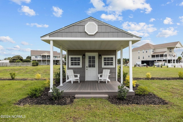 rear view of property with a yard