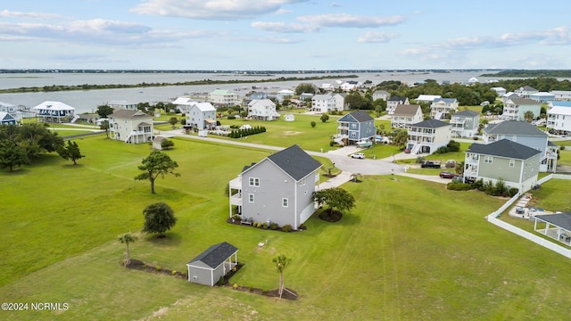 drone / aerial view featuring a water view and a residential view