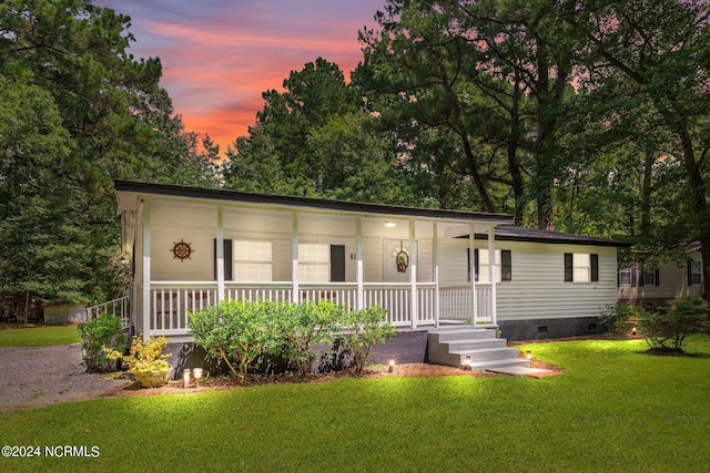 view of front of property with a lawn and covered porch