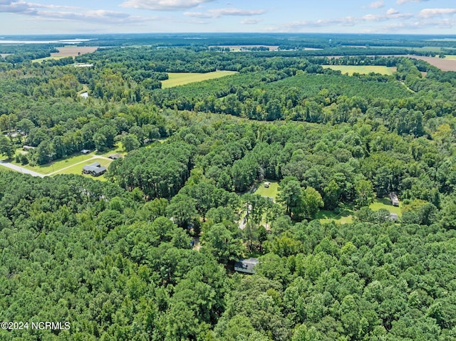 birds eye view of property featuring a view of trees