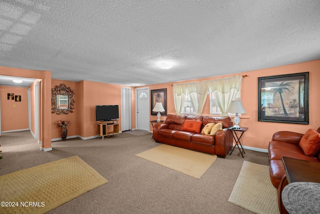 carpeted living room featuring a textured ceiling and baseboards