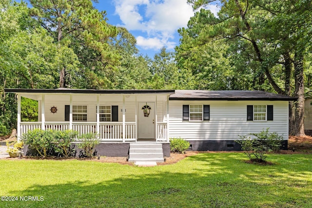 ranch-style house with a front lawn and a porch