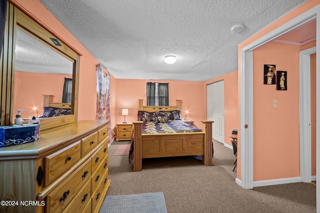 bedroom featuring a textured ceiling, carpet flooring, and a closet