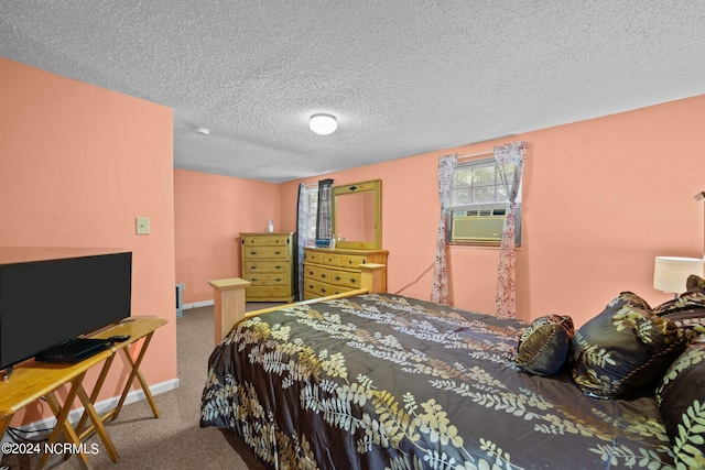 bedroom with a textured ceiling and carpet flooring