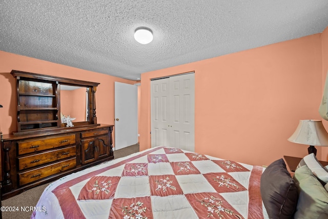 carpeted bedroom with a closet and a textured ceiling