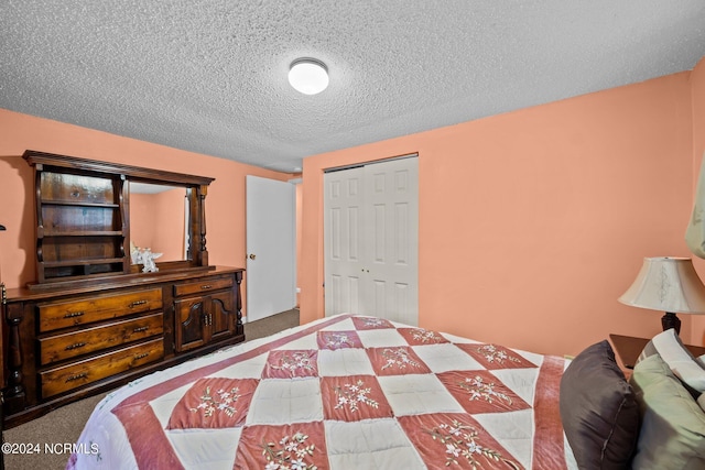 bedroom with a textured ceiling, a closet, and carpet flooring