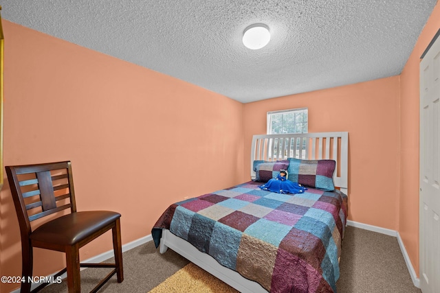 carpeted bedroom featuring a textured ceiling and a closet