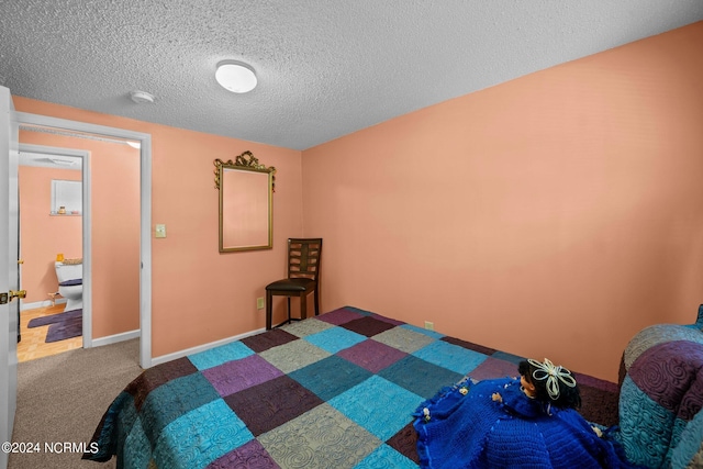 carpeted bedroom featuring a textured ceiling