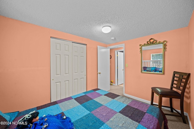 bedroom with light carpet, a textured ceiling, and a closet