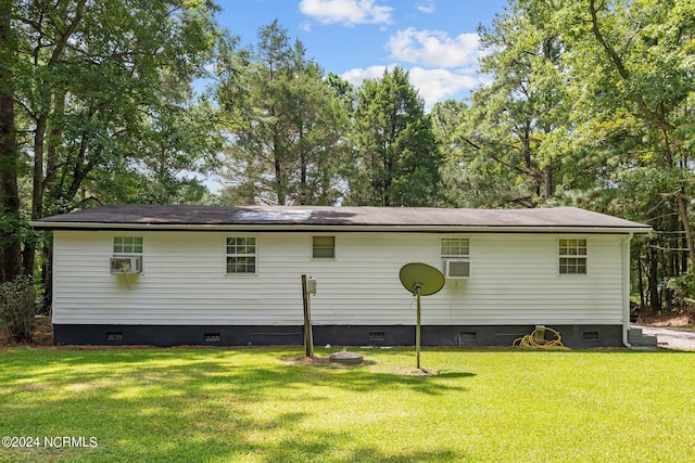 back of property with a lawn