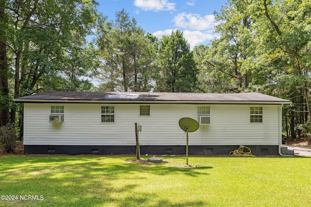 rear view of property with crawl space and a yard