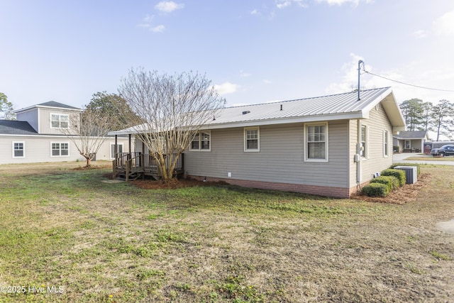 rear view of property featuring a yard