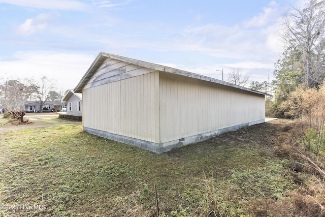 view of side of home with a yard