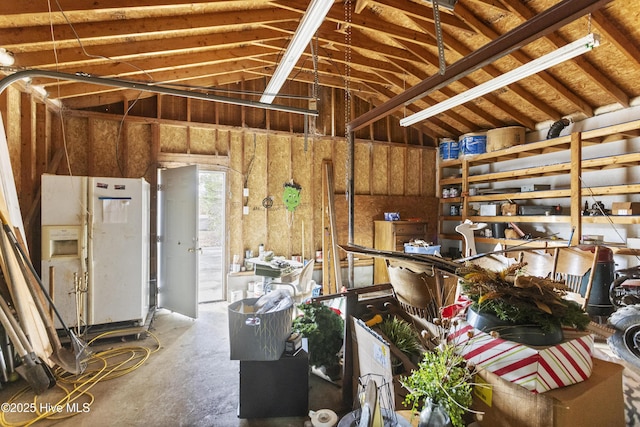 miscellaneous room featuring concrete floors and vaulted ceiling