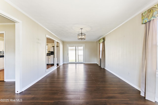 interior space with a chandelier, dark hardwood / wood-style floors, and ornamental molding