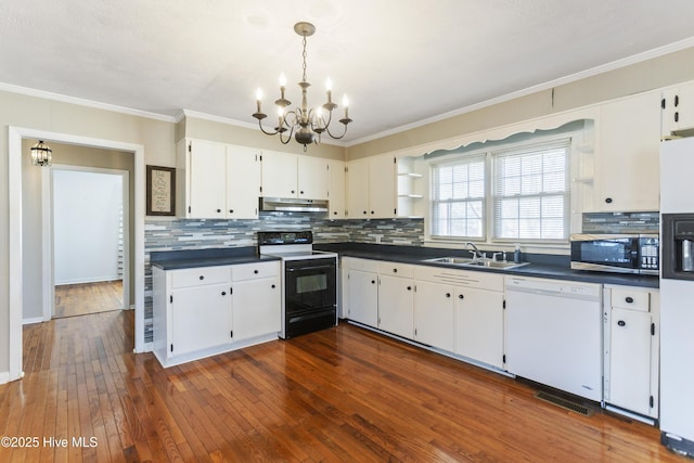 kitchen featuring white cabinetry, sink, an inviting chandelier, dark hardwood / wood-style flooring, and white appliances