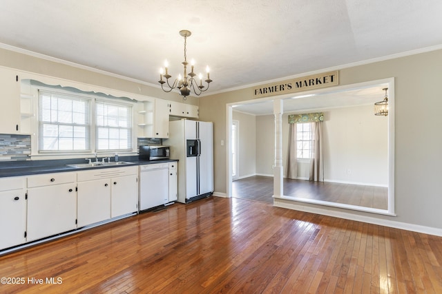 kitchen with white appliances, white cabinets, sink, decorative backsplash, and dark hardwood / wood-style floors