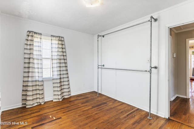 unfurnished bedroom with dark wood-type flooring and ornamental molding