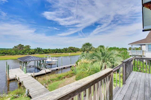 exterior space featuring a boat dock and a water view