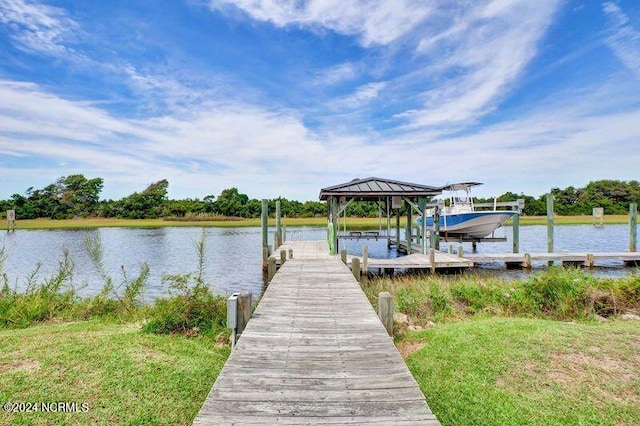 dock area with a water view and boat lift