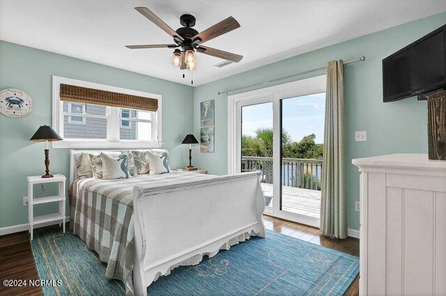 bedroom featuring access to outside, multiple windows, ceiling fan, and dark hardwood / wood-style flooring