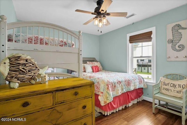 bedroom with ceiling fan and dark wood-type flooring