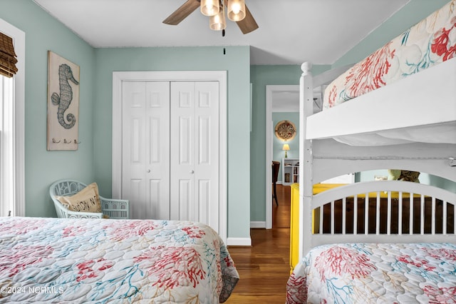 bedroom with ceiling fan, a closet, and dark wood-type flooring