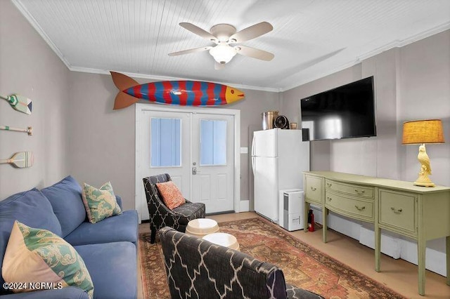 living area with a ceiling fan and crown molding