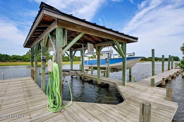 dock area with a water view and boat lift