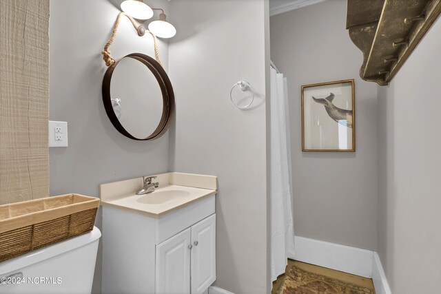 bathroom featuring vanity and toilet