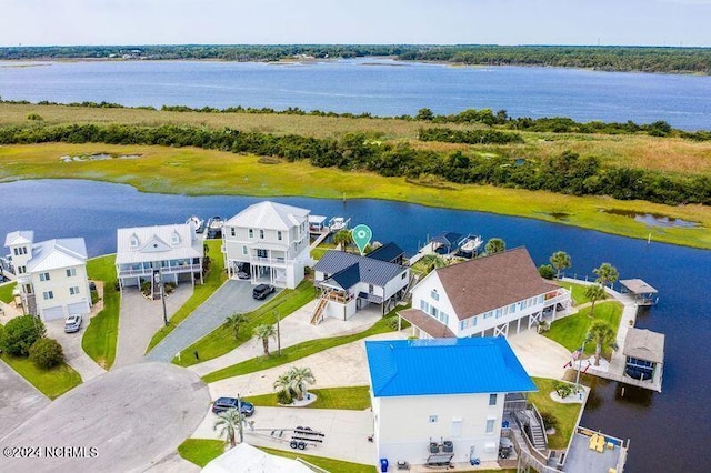 drone / aerial view featuring a residential view and a water view