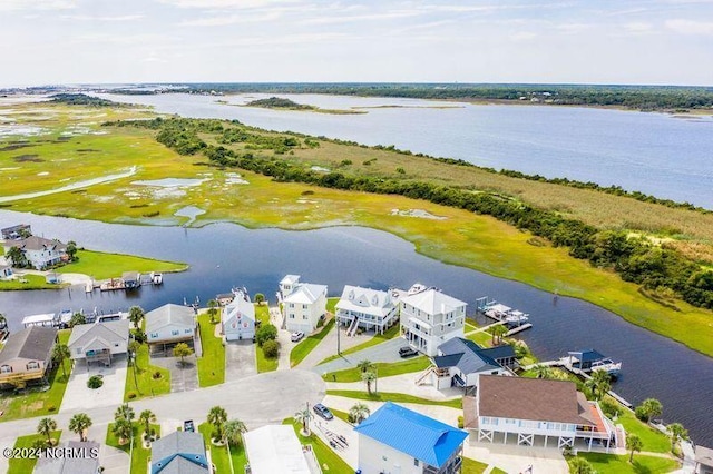 birds eye view of property with a water view and a residential view