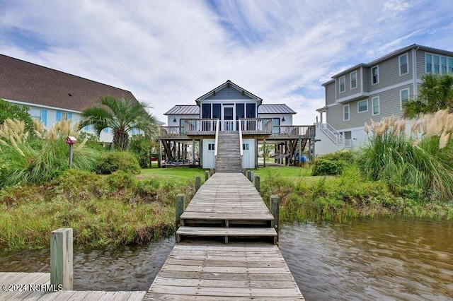 dock area featuring stairs and a deck with water view