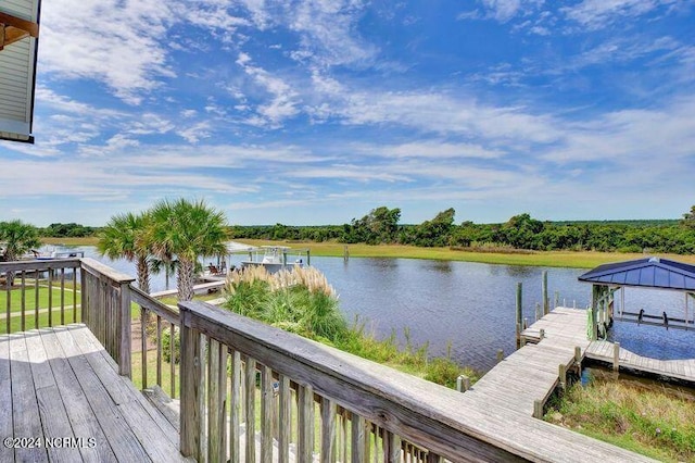 wooden terrace featuring a boat dock and a water view