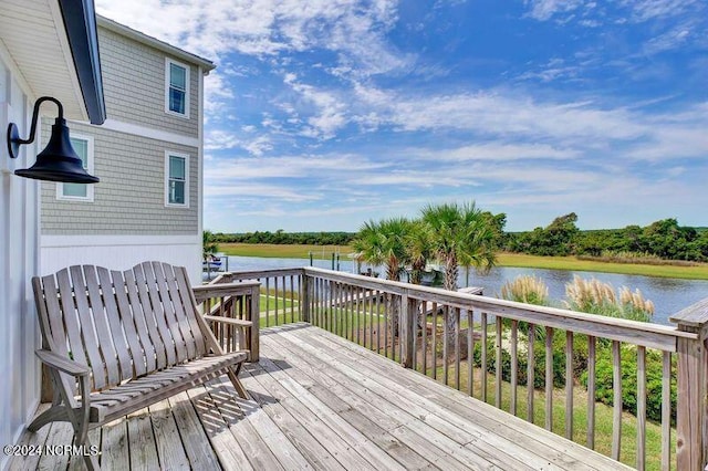 wooden terrace featuring a water view