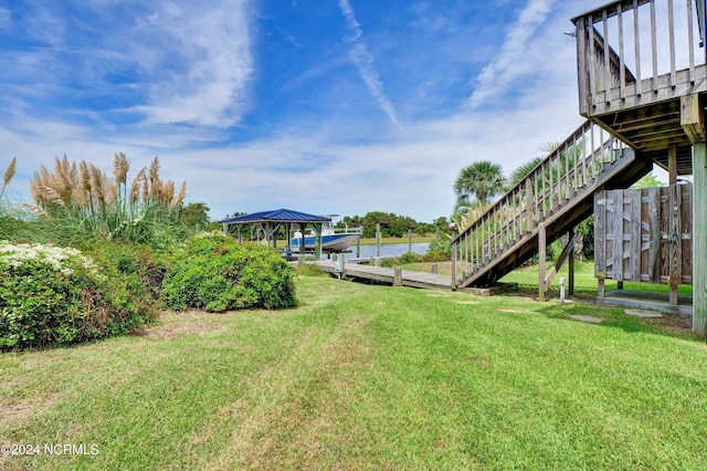 view of yard featuring stairs and a boat dock