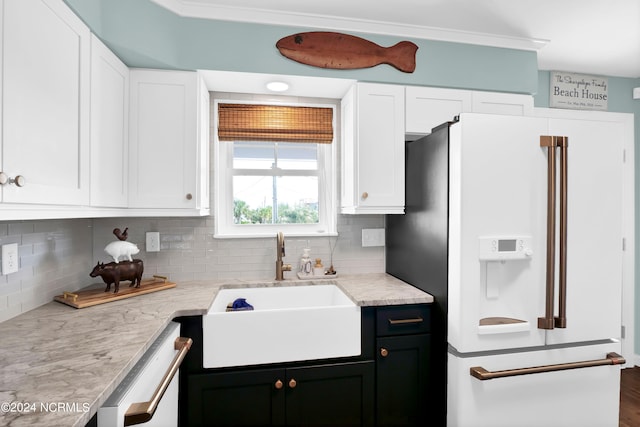 kitchen with decorative backsplash, white appliances, white cabinetry, and sink