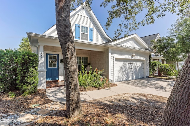 view of front of home featuring covered porch and a garage